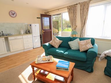 A living room with a sofa and coffee table at Little Barn in Cucklington near Wincanton