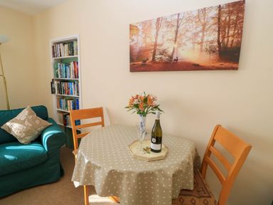 A dining room with a table and chairs at Little Barn in Cucklington near Wincanton