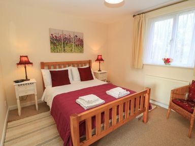 A bedroom with a bed and lamps at Little Barn Cucklington near Wincanton