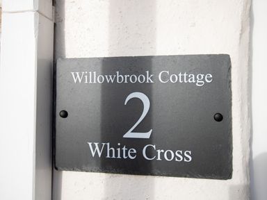 A house number sign reading Willowbrook Cottage 2 White Cross on a wall at Willowbrook Cottage Litton Cheney