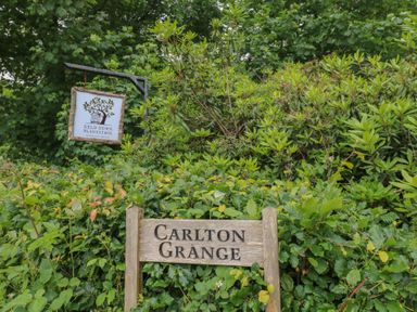 A sign for Carlton Grange at Keld Down Plantation