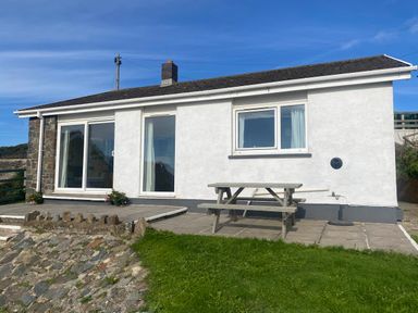 A house with a table on stone patio at Valley High in Solva