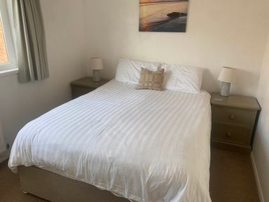 A bedroom with a bed and nightstand at Valley High in Solva