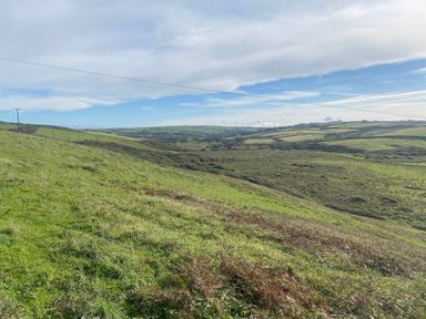 A landscape view of hills and electric poles at Valley High Solva
