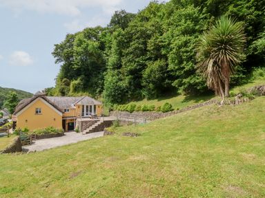 A house with a garden and trees at Old Maids Cottage in Woolacombe