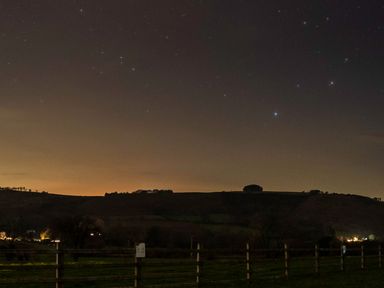 A view of a night sky with stars and hills at Bwthyn Bach Brefi