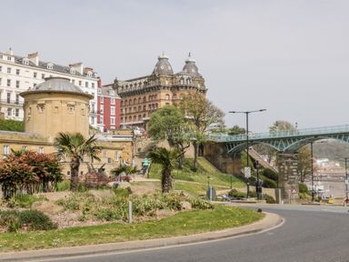A street view with historic buildings a curved road a bridge and landscaped greenery at Royal Victoria House in Scarborough