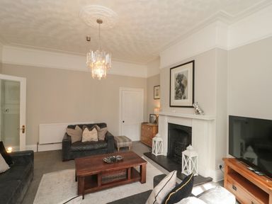 A living room with sofa and coffee table at Royal Victoria House in Scarborough