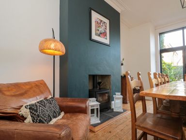 A dining room with a sofa and table at Royal Victoria House in Scarborough