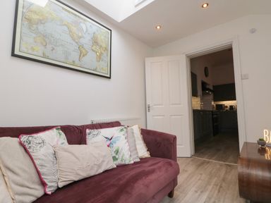 A living room with a sofa and map on the wall at Royal Victoria House Scarborough