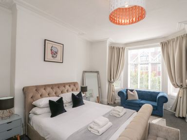 A bedroom with a bed and a sofa at Royal Victoria House in Scarborough