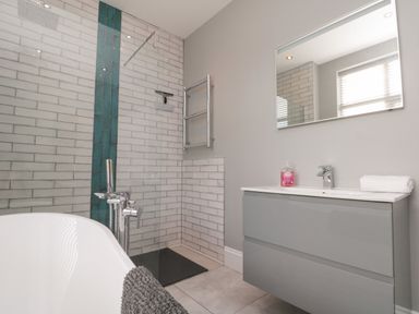 A bathroom with a tub and shower at Royal Victoria House in Scarborough