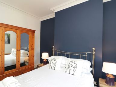 A bedroom with a bed and wardrobe at Royal Victoria House Scarborough