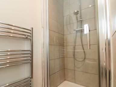 A shower area with a towel radiator at Royal Victoria House Scarborough