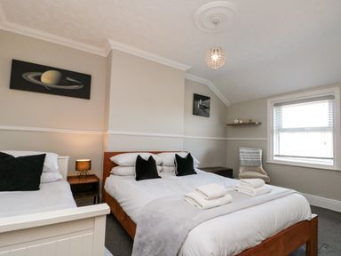 A bedroom with two beds and a window at Royal Victoria House, Scarborough