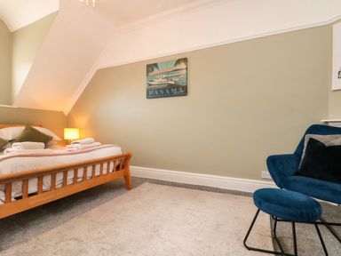 A bedroom with a bed and a chair at Royal Victoria House in Scarborough