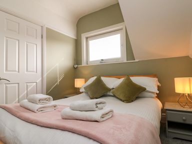 A bedroom with a bed and pillows at Royal Victoria House in Scarborough