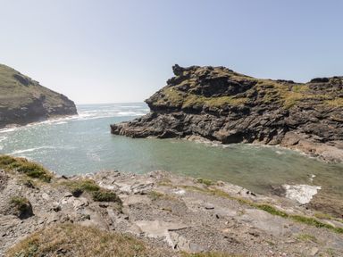 Rocky coastline with cliffs and water at Harbour Cottage in Boscastle