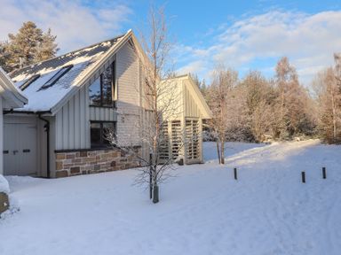 A house in a snowy outdoor area at Red Deer Lodge Feshiebridge near Aviemore
