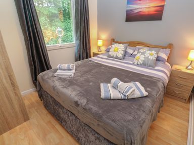 A bedroom with a double bed bedside tables and lamps at 11 Tremore in Liskeard