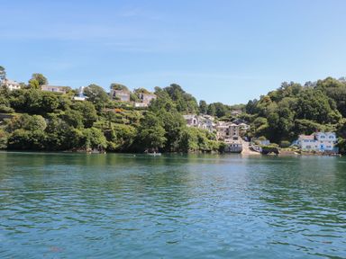 A body of water with houses and trees on the shore at 11 Tremore in Liskeard