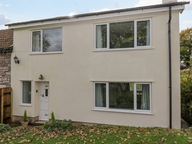 Exterior view of a two-story house with white walls and multiple windows at Pool House The Narth near Trellech