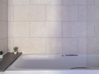 A bathtub with two small potted plants on a ledge at Grassholme in Hawkshead