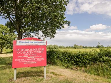 An outdoor sign for Batsford Arboretum and Garden Centre with trees and grassy fields in the background at Rosemead in Moreton-In-Marsh