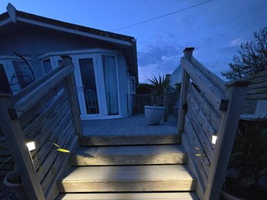 An outdoor area with stairs leading to a house at Caban Tywod in Abersoch
