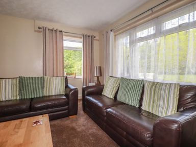 A living room with sofas and a coffee table at Underlanes in Boscastle