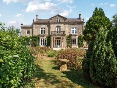 A house with a garden and trees at Milton Manor in Milton On Stour