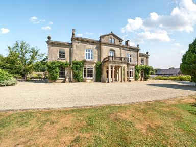 A house with windows and an entrance at Milton Manor in Milton On Stour