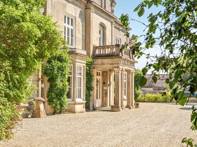 A building with columns and windows at Milton Manor in Milton On Stour