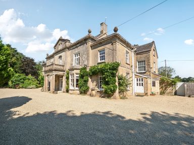 An exterior view of a house with windows and door at Milton Manor in Milton On Stour