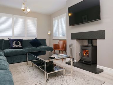 A living room with a blue sofa and coffee table at Bishop Fell in Newby Bridge