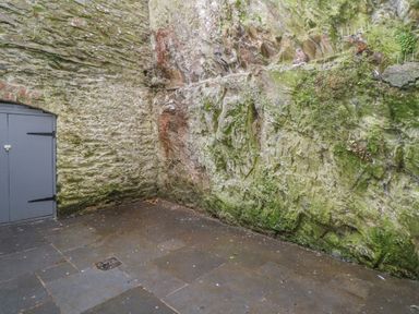 An outdoor corner with stone walls and a paved floor at 1 River View in Looe
