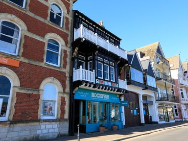 A street view showing a row of buildings including the Rockfish seafood restaurant at 2 Embankment House in Dartmouth