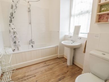 A bathroom with a bathtub a shower sink and a toilet with window at Manod View in Blaenau Ffestiniog