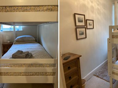 A bedroom with a bunk bed a bedside table with a lamp a wooden chest of drawers and framed pictures on the wall at Manod View in Blaenau Ffestiniog