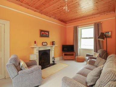 A living room with armchairs a sofa a fireplace and a television at Newtown East near Kilkee County Clare