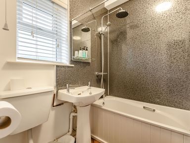 A bathroom with a toilet sink bathtub and shower at The Boars Head Pub in Bishops Castle
