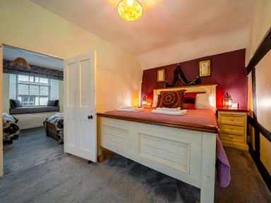 A bedroom with a bed and a view of another room at The Boars Head Pub in Bishop's Castle
