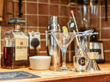 A bar setup with a cocktail glass and various tools at The Boars Head Pub in Bishop's Castle