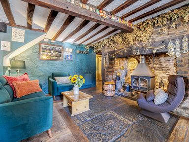 A living room with a fireplace and seating area at The Boars Head Pub in Bishop's Castle