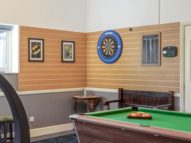 A games room with a dartboard and pool table at The Boars Head Pub in Bishop's Castle