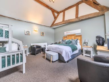 A guest room with a bunk bed and a double bed at The Boars Head Pub in Bishop's Castle