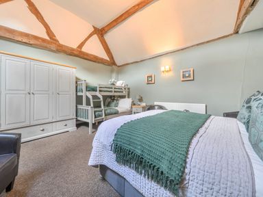 A bedroom with a bed and bunk bed at The Boars Head Pub in Bishop's Castle