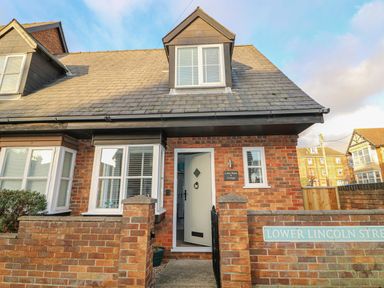 A brick house with a tiled roof and white windows on Lower Lincoln Street at Little Wash Cottage in Hunstanton