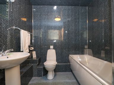 A bathroom with a sink a toilet and a bathtub at The Roundhouse in Bude