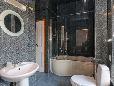 A bathroom with a sink toilet and bathtub with shower at The Shippon in Bude